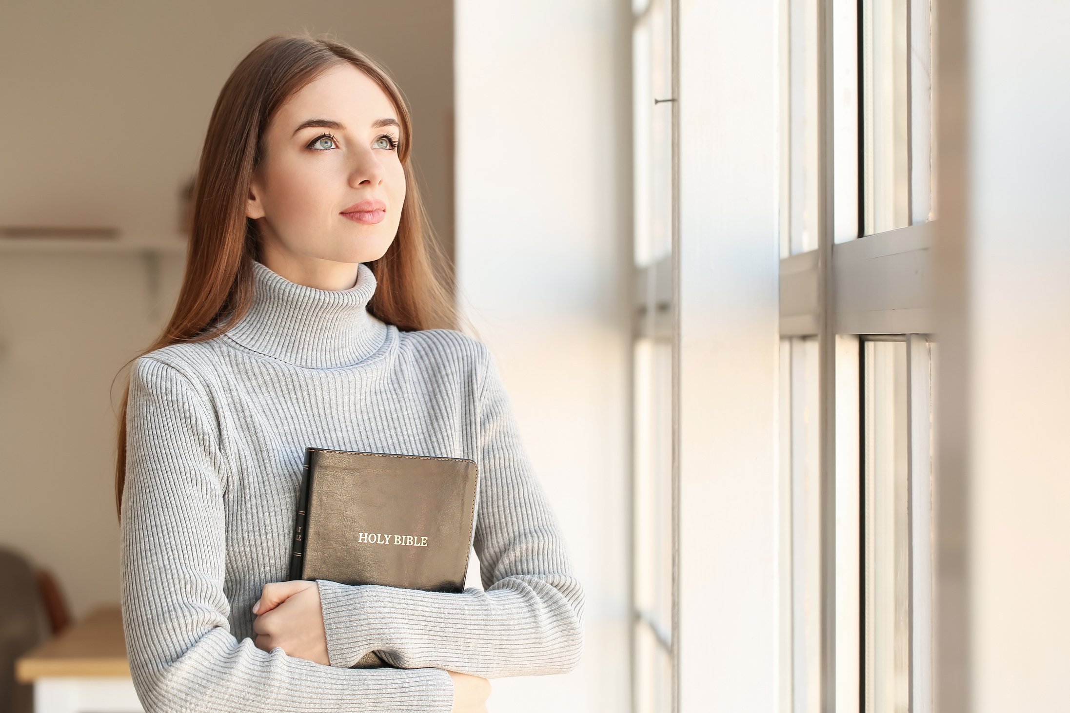 Young Woman with Bible at Home